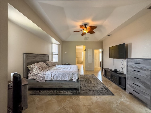 bedroom featuring a raised ceiling and ceiling fan