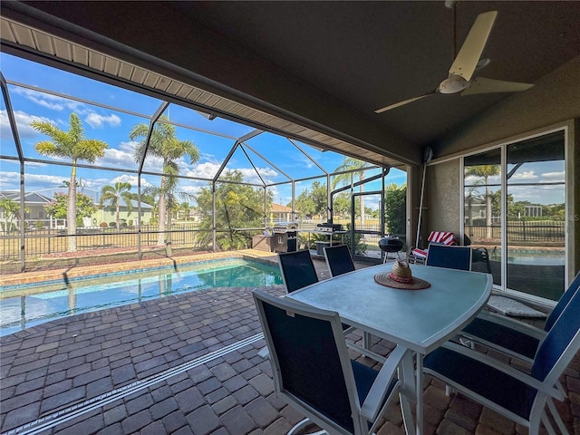 view of patio featuring a lanai, ceiling fan, and a fenced in pool