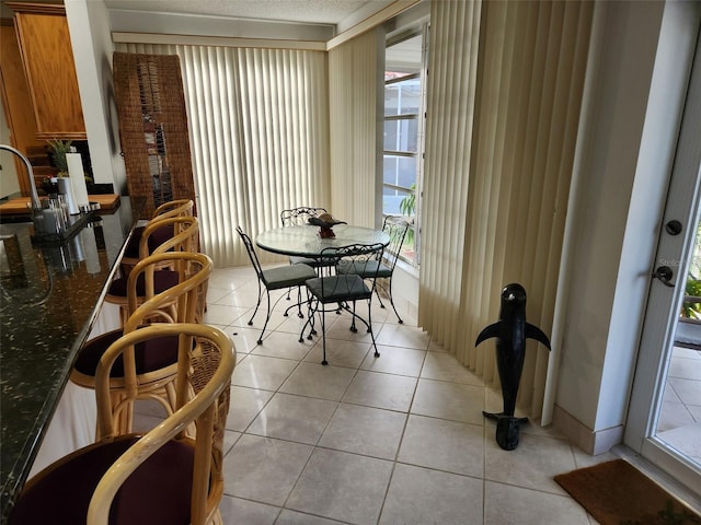 dining space featuring light tile patterned floors