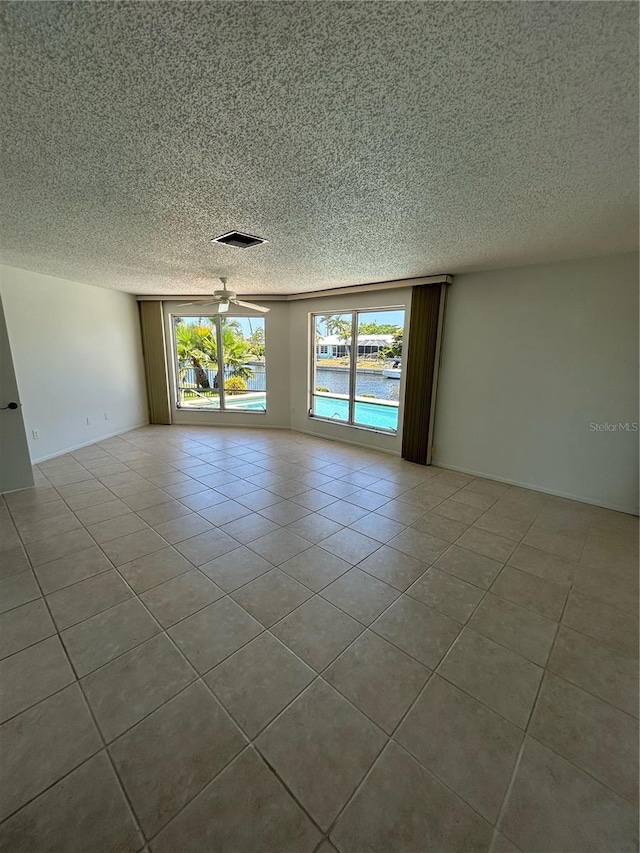 spare room featuring ceiling fan and light tile patterned flooring