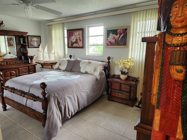 bedroom with light tile patterned floors, a textured ceiling, and ceiling fan