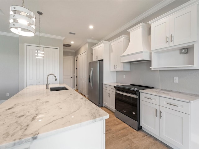 kitchen with stainless steel appliances, white cabinets, sink, pendant lighting, and premium range hood