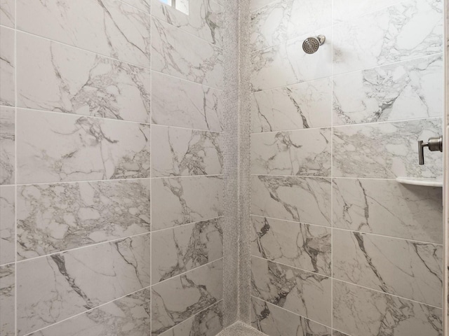 interior details featuring tiled shower