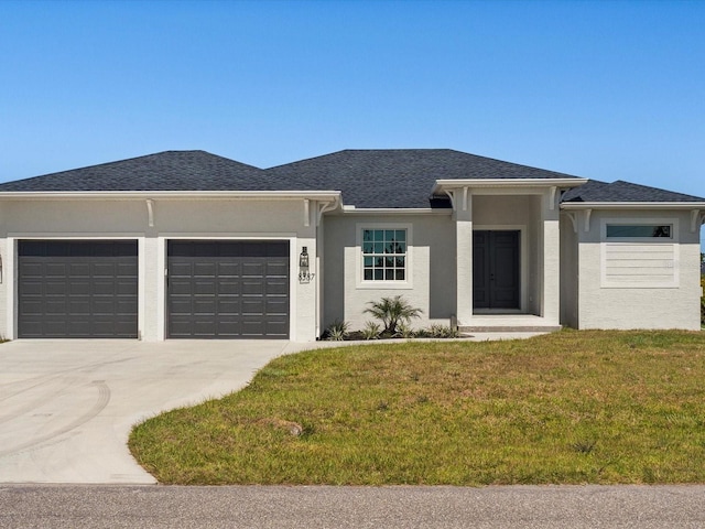 view of front of property featuring a garage and a front lawn