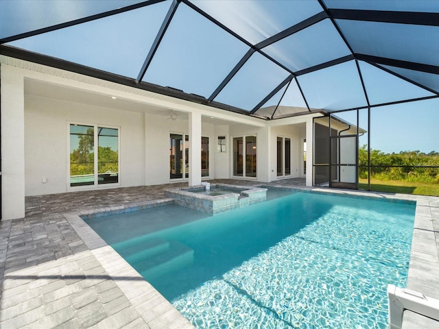 view of swimming pool with ceiling fan, a lanai, an in ground hot tub, and a patio area