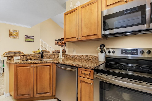 kitchen featuring appliances with stainless steel finishes, sink, kitchen peninsula, and dark stone counters