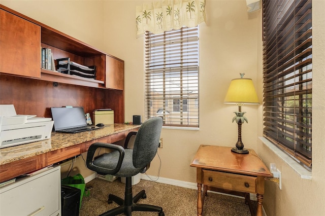 home office with carpet flooring and built in desk