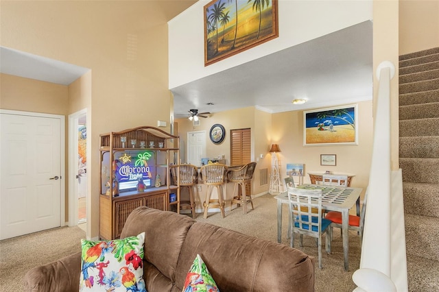 carpeted living room featuring ceiling fan