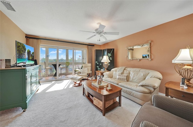 living room with ceiling fan and light carpet