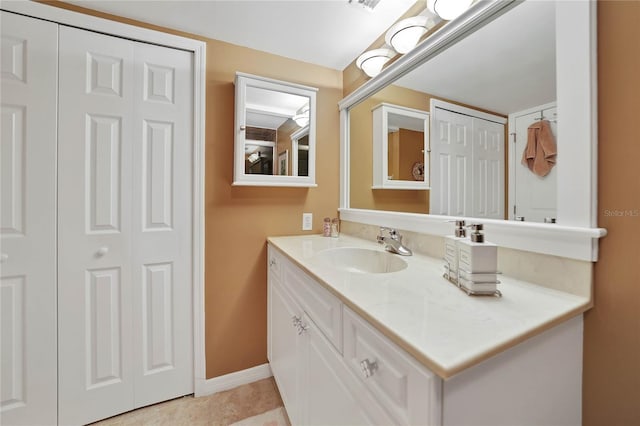 bathroom with tile patterned flooring and vanity