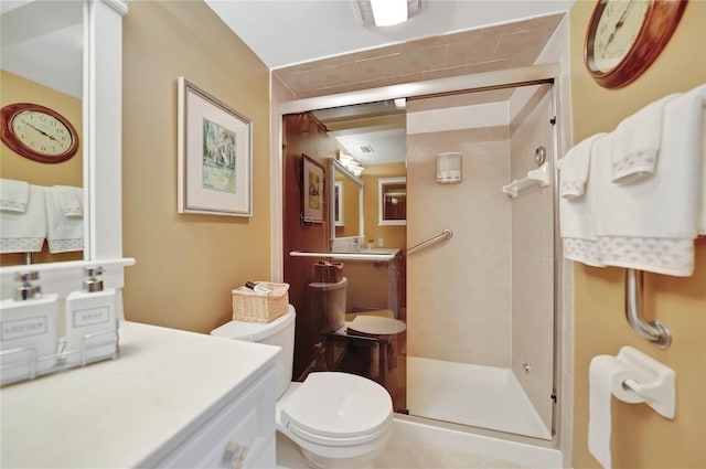 bathroom with vanity, toilet, and an enclosed shower