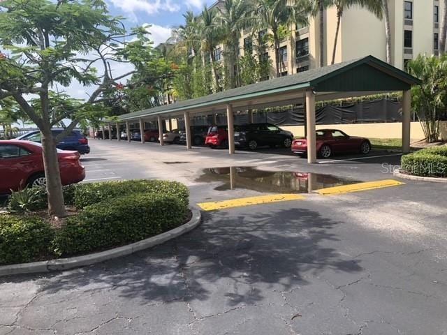 view of parking / parking lot featuring a carport