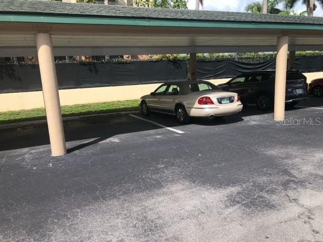 view of parking / parking lot featuring a carport