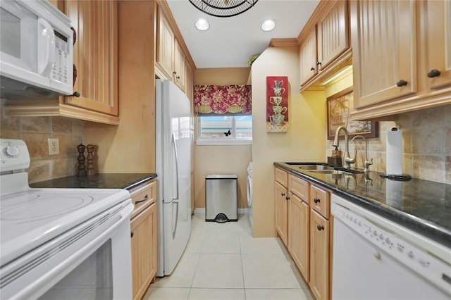 kitchen with white appliances, sink, light tile patterned floors, and tasteful backsplash