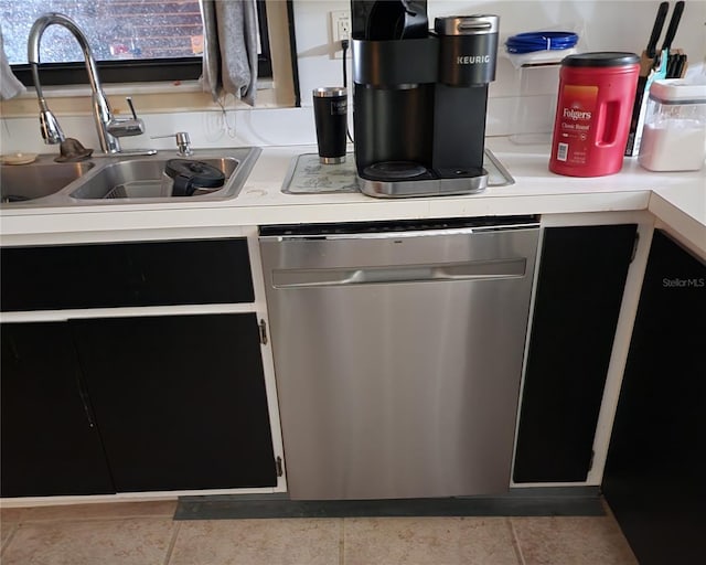 kitchen featuring light tile patterned floors, sink, and stainless steel dishwasher