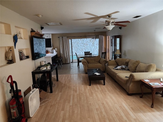 living room featuring ceiling fan and light hardwood / wood-style floors