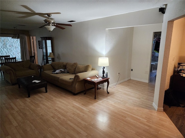 living room with light hardwood / wood-style floors and ceiling fan