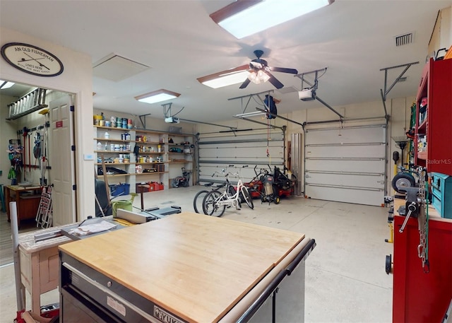 garage with a garage door opener and ceiling fan