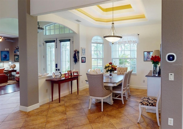 dining area featuring ceiling fan, ornamental molding, a wealth of natural light, and french doors