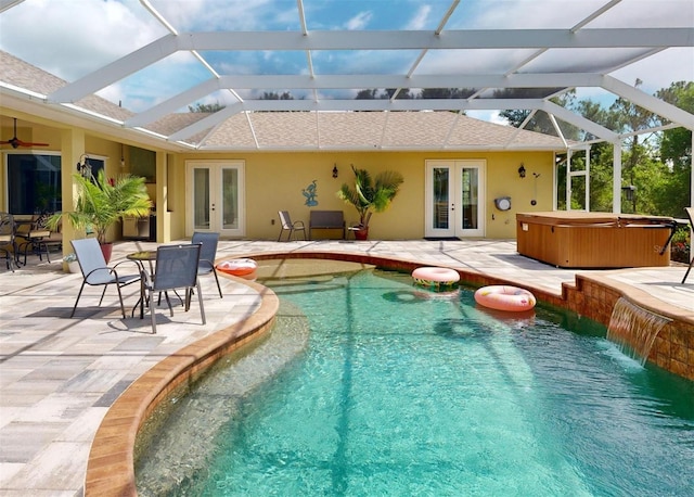 view of swimming pool featuring french doors, glass enclosure, a hot tub, and a patio area