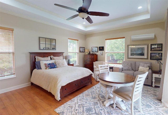 bedroom with a wall mounted AC, light wood-type flooring, multiple windows, and ceiling fan