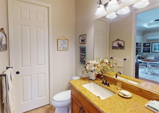 bathroom featuring toilet, tile patterned flooring, vanity, and ornamental molding