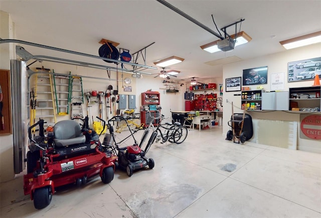 garage with a workshop area, a garage door opener, and ceiling fan