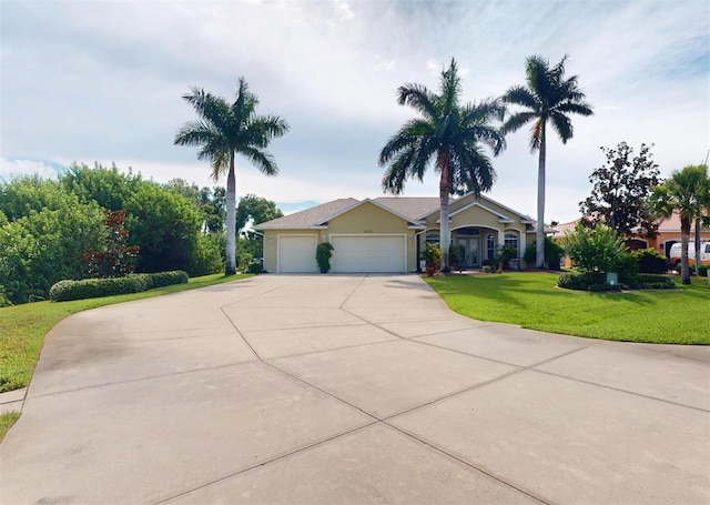 view of front of house with a garage and a front yard