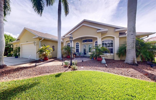 ranch-style home with french doors, a front yard, and a garage