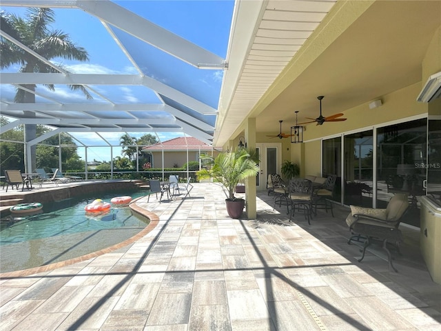 view of swimming pool featuring a lanai and a patio