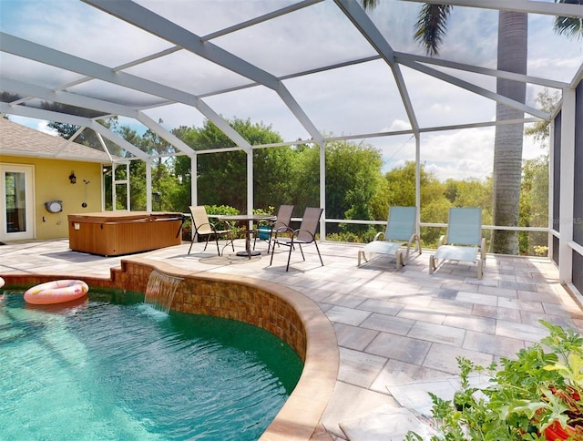 view of pool with pool water feature, a patio area, a lanai, and a hot tub