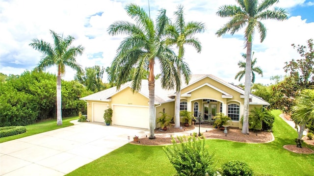 ranch-style home with french doors, a front lawn, and a garage