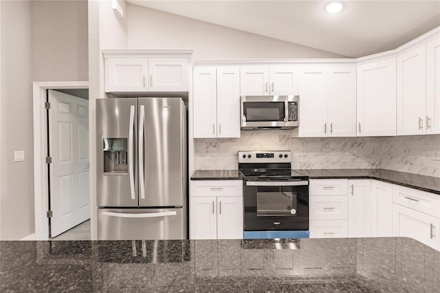 kitchen with backsplash, white cabinetry, dark stone counters, and appliances with stainless steel finishes