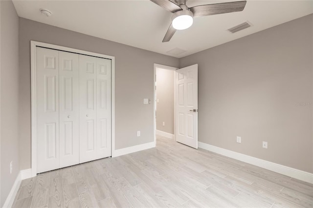 unfurnished bedroom featuring ceiling fan, light hardwood / wood-style flooring, and a closet