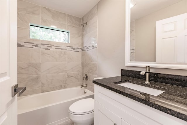 full bathroom with vanity, tiled shower / bath combo, and toilet