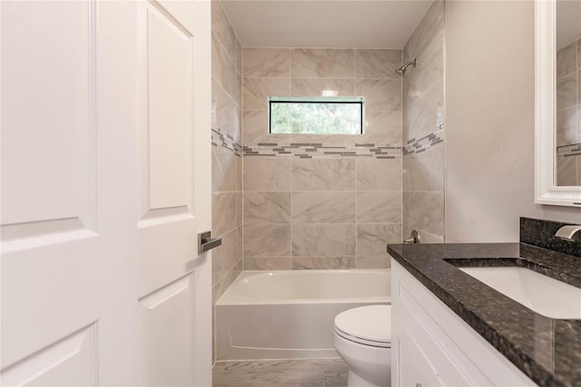 full bathroom featuring vanity, toilet, and tiled shower / bath