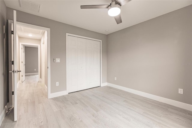 unfurnished bedroom featuring ceiling fan, light wood-type flooring, and a closet