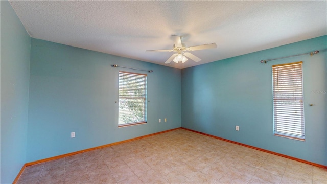 spare room with ceiling fan and a textured ceiling