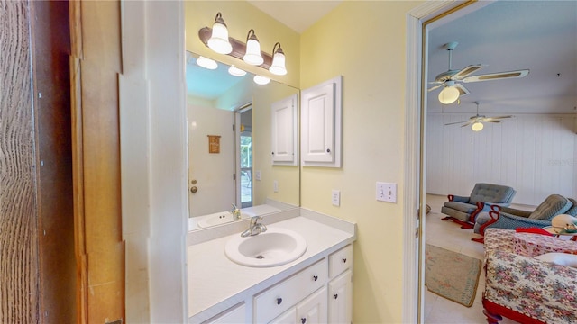 bathroom featuring tile patterned floors, vanity, wood walls, and ceiling fan