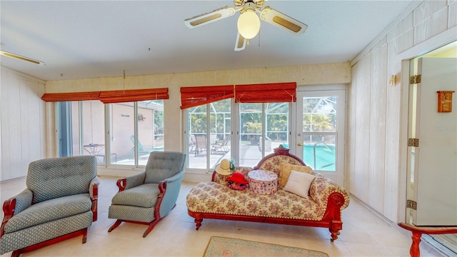 sunroom featuring ceiling fan