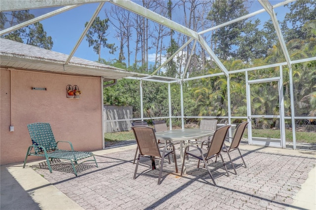 view of patio featuring glass enclosure