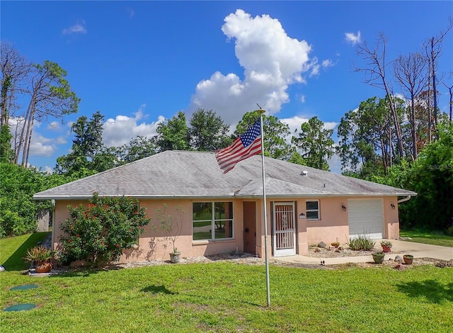 single story home featuring a garage and a front yard