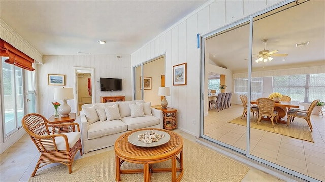 tiled living room with ceiling fan