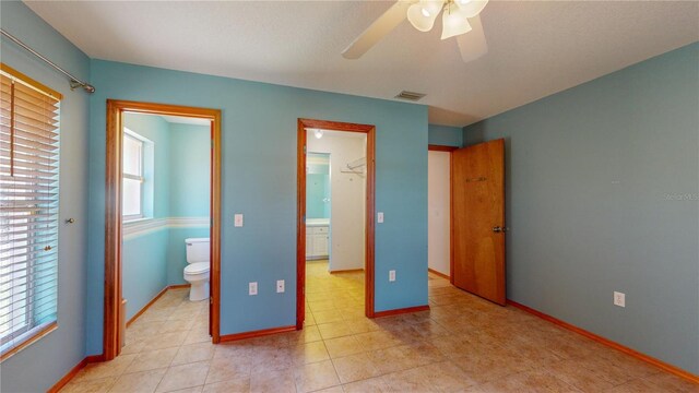 bedroom with ceiling fan and ensuite bath