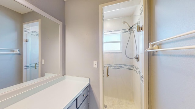 bathroom featuring vanity and an enclosed shower