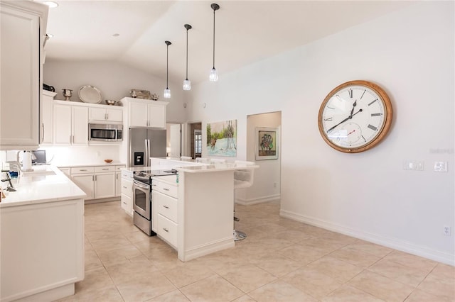 kitchen featuring appliances with stainless steel finishes, a center island, hanging light fixtures, lofted ceiling, and light tile patterned flooring