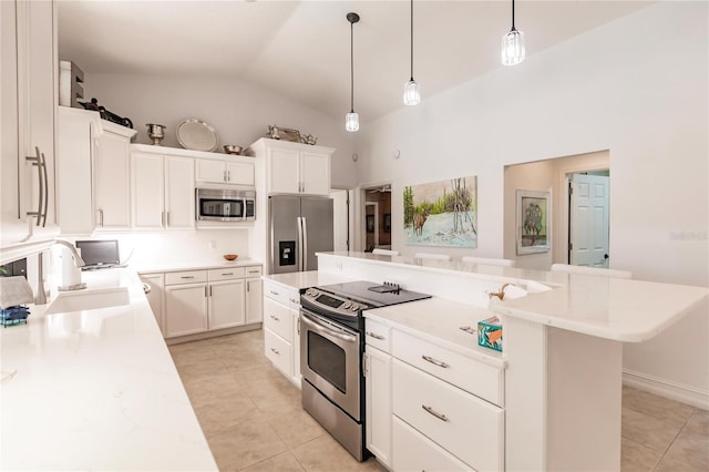 kitchen with white cabinetry, sink, a center island, pendant lighting, and appliances with stainless steel finishes