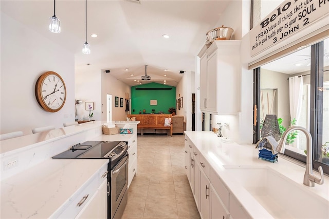 kitchen featuring electric range, sink, white cabinets, and hanging light fixtures