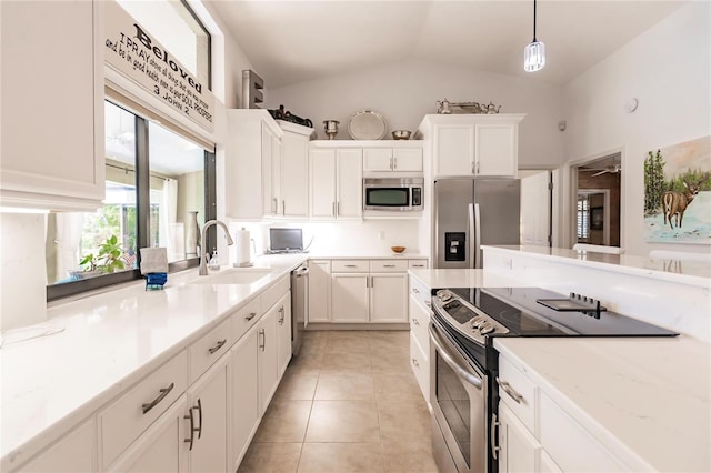 kitchen with white cabinetry, hanging light fixtures, lofted ceiling, and appliances with stainless steel finishes