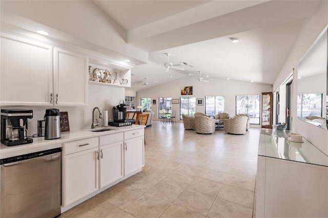 kitchen with white cabinets, dishwasher, lofted ceiling, and sink